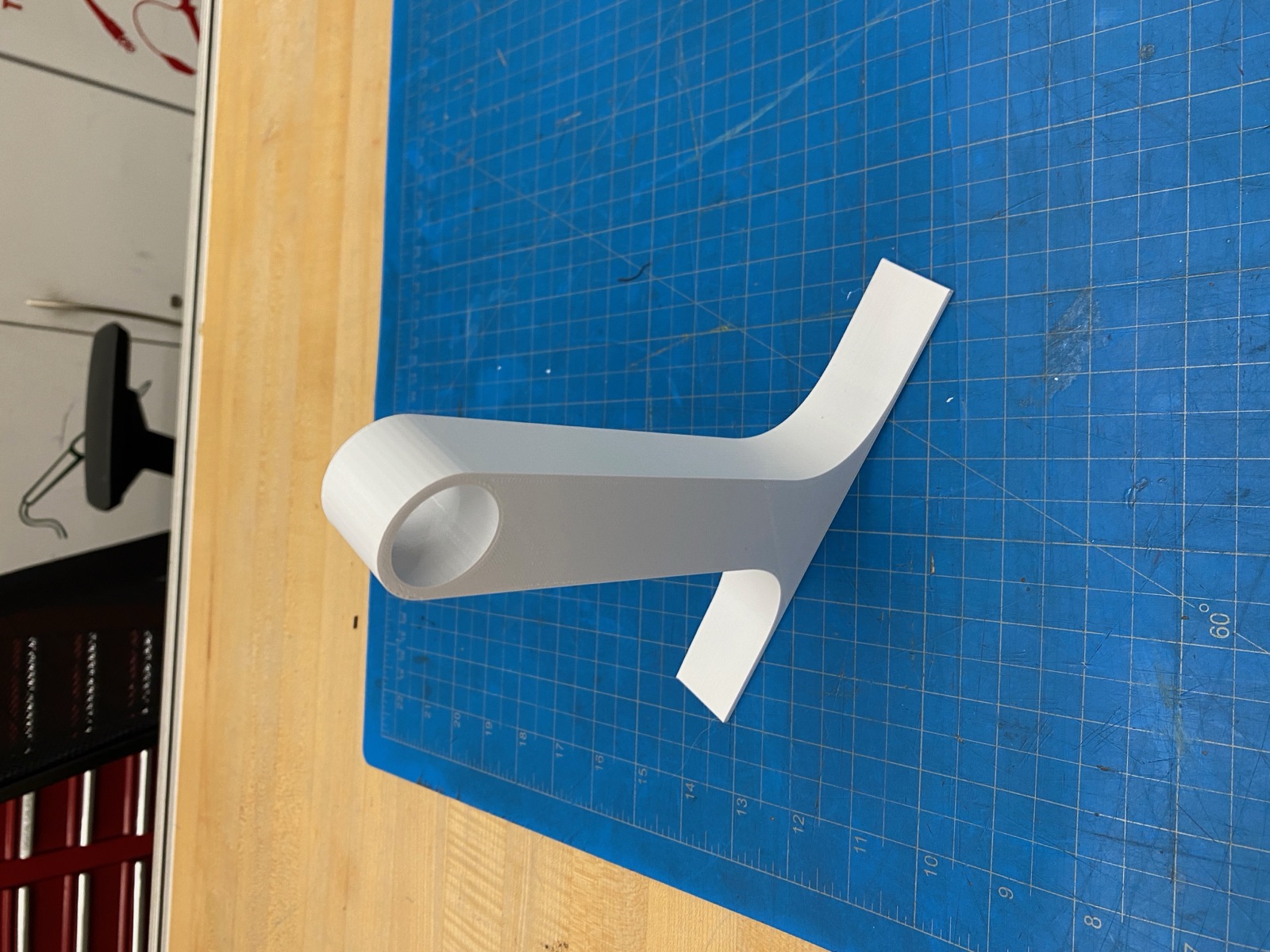Single PLA leg with round peg-receiving hole.