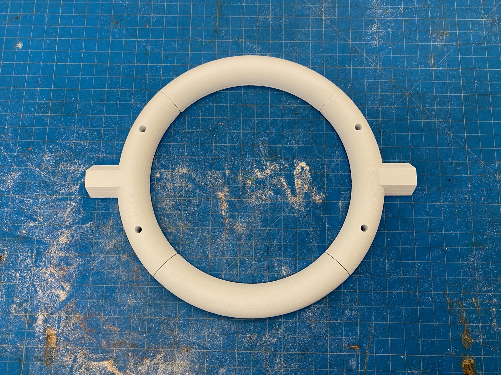 v2: PLA ring with hex pegs visible.