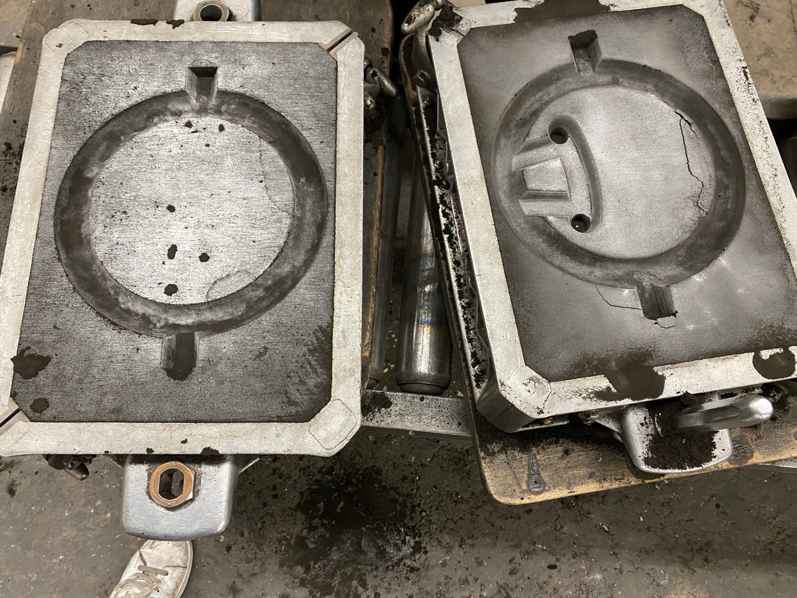 Both halves of the sand mold opened, showing cope and drag cavities side by side.